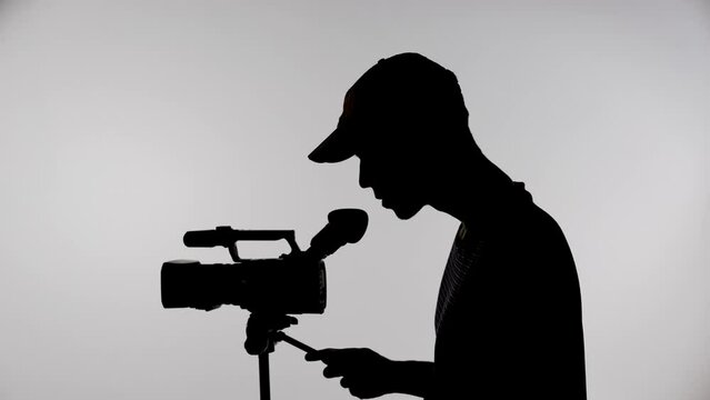 Silhouette of a videographer with a camera