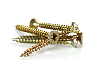 Heap of yellow screws isolated on a white background.