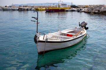 Fototapeta premium White boat with a motor stands in the harbor in Croatia