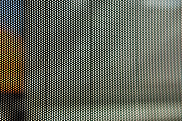 Mesh texture on glass. Shooting window. Small cage.