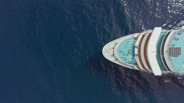 Cruise ship sailing in the ocean aerial view from above. Romantic holiday vacation on luxury cruise liner. Travel across ocean summer journey concept
