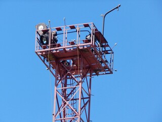 Lighting tower. Platform with spotlights on top of the metal tower.