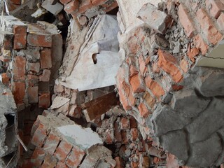 Fragments of a brick wall. Ruins of a demolished house. - 506669121