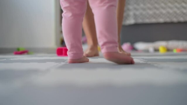 baby first steps with mom bottom view legs