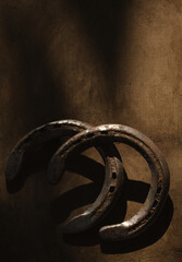 Old horseshoes on wood texture rustic background for western industry lifestyle with copy space.