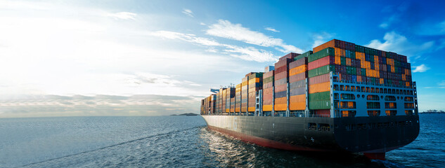 Stern of large cargo ship import export container box on the ocean sea on blue sky back ground...