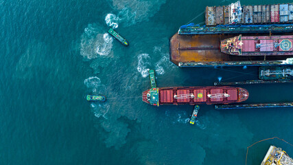Tug boat drag pull cargo ship from dry dock concept maintenance service - obrazy, fototapety, plakaty