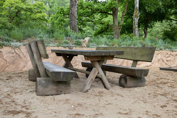 table with benches in the forest in nature in summer