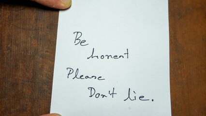 Hand written motivational word Be honest Please Don't lie. Men hand holding lifestyle motivational...