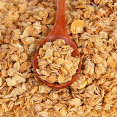 Oatmeal cereal breakfast in wooden spoon textured background