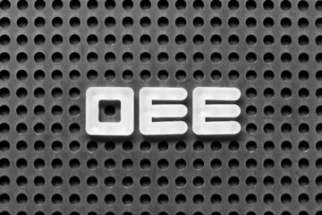 White alphabet letter in word OEE (abbreviation of overall equipment effectiveness) on black...