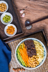 Beijing food old Beijing fried sauce noodles placed on wooden table