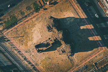 Aerial view of Pra Prang Sam Yod or Phra Prang Sam Yot ruin temple with monkeys, in Lopburi, Thailand