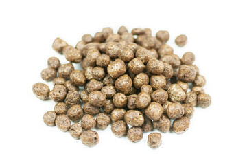 Corn chocolate balls close-up on a white isolated background. A quick healthy dry breakfast, add milk. Side view.