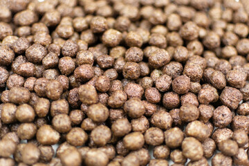 Background (texture) of dried corn chocolate balls close-up. Quick healthy breakfast, add milk