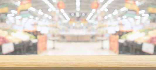 Wood table top with supermarket grocery store blurred defocused background with bokeh light for product display