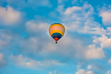 Balloon on the background of blue sky with white clouds in summer
