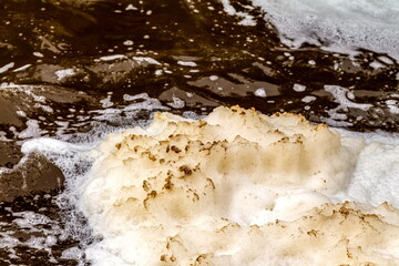 Foam on the river after a waterfall close - up . Russia. Ural.