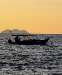 silhouette of a fishing boat at sunset