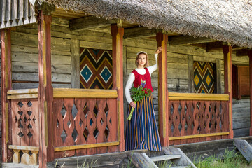 Latvian woman in traditional clothing. Ligo folk.