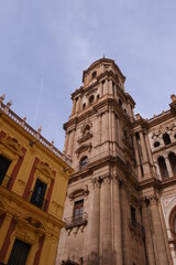 Fototapeta premium Symmetrical fragment of architecture of the Cathedral Tower. The Cathedral of Malaga is a national landmark. Old Town of Malaga, Andalusia, southern Spain, Europa.