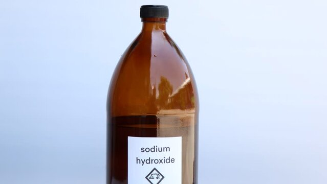 Sodium hydroxide in bottle, chemical in the laboratory and industry