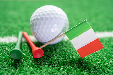 Golf ball with Italy flag and tee on green lawn or grass is most popular sport in the world.