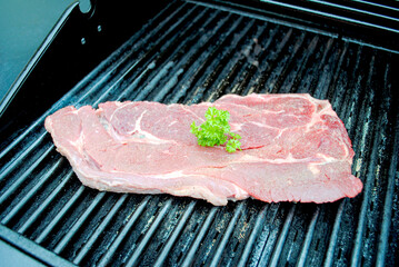 Raw Chuck Beef Steak on a Hot Summer Grill