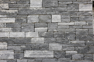 Bricks in a grey Stone Wall
