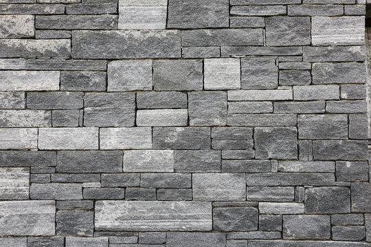 Fototapeta Bricks in a grey Stone Wall