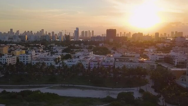 Aerial view of the South beach cityscape, sunset in Miami, Florida, USA - tracking, drone shot