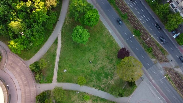 A green Flixbus on the road To Center 
Dramatic aerial view flight slowly tilt up drone footage
of Berlin Prenzlauer Berg Allee Summer 2022. Cinematic travel guide by Philipp Marnitz