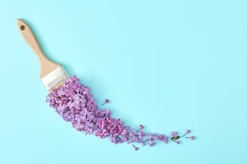 Fotobehang Creative composition with flower and paint brush on pastel blue background. Minimal nature concept, flat lay, copy space. © Goncharuk film
