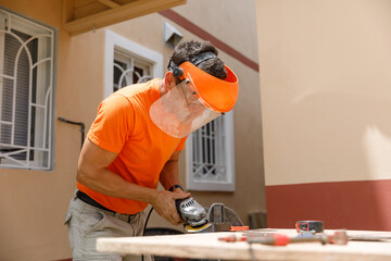 A man in his yard is engaged in locksmith work. Hobby, in a home workshop.