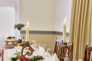 Burning candles on the holiday table.