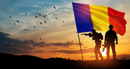 Silhouettes of soldiers with national flag on background of sunset. Romania National Day, the Great...