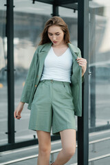 Obraz premium Girl walking down the street in summer dress. Summer clothes collection.