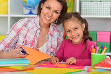 Mother teaches her cute daughter to do craft items