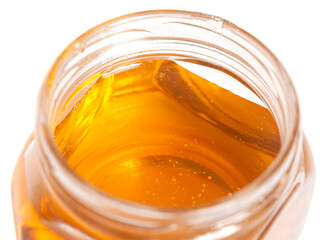 glass honey jar isolated on white background