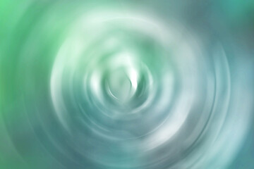 Blurred gradient radial motion summer green and blue background. Abstract circular texture