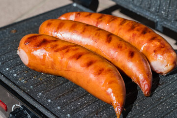 Sausages on an electric grill.