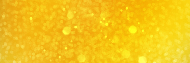 Bright yellow sparkling glitter bokeh background, banner texture. Abstract defocused lights header. Wide screen wallpaper. Panoramic web banner with copy space for design