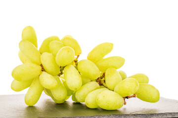 One bunch of white seedless grapes on a slate stone, close-up, isolated on a white background.