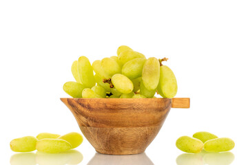 One bunch of white seedless grapes in a wooden cup, close-up, isolated on a white background.