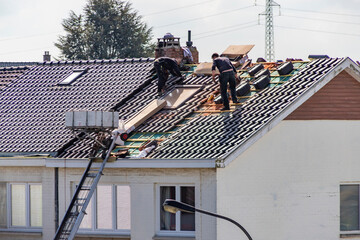 Ouvriers procédant à l'isolation d'un toit  - obrazy, fototapety, plakaty