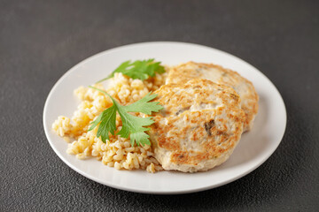 Chicken or vegetable cutlets with a side dish of bulgur in a plate on the table. Diet nutrition