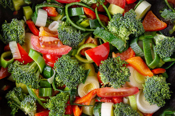 vegetable stew of broccoli, leeks, tomatoes, peppers close-up