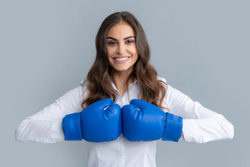 Woman in boxing gloves. Businesswoman wearing boxing gloves ready to fight. Strength, power or...