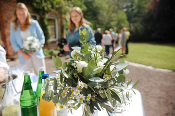 Flowers for a champagne reception outside. Drinks and fresh flowers for outdoor party in summer