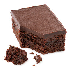 Broken chocolate cake square with chocolate icing next to crumbs.
